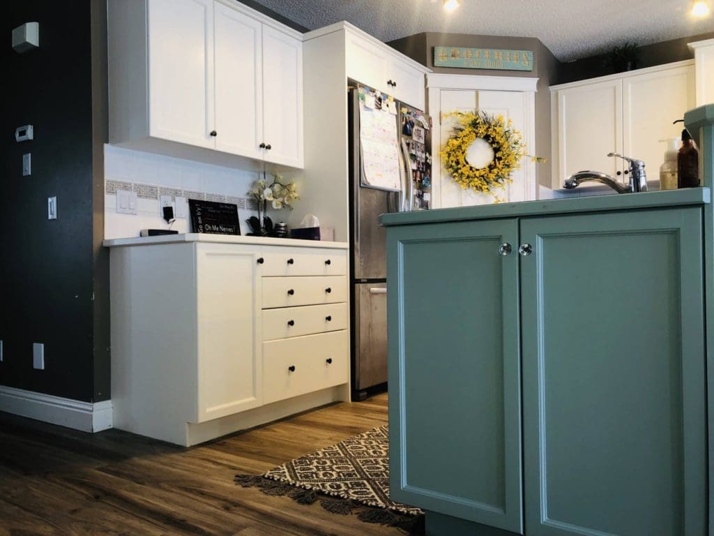 White painted cabinets with chic teal accent island