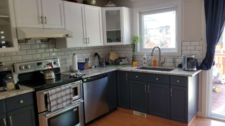 Matching white window frame white kitchen with navy accent lowers